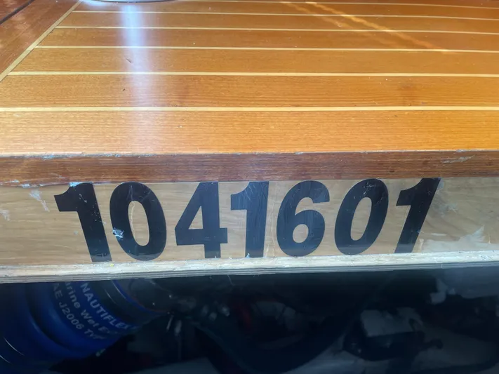 Minkie B Yacht Photos Pics Wooden surface with number 1041601, Lyman-Morse Custom Flybridge, 1997 model.