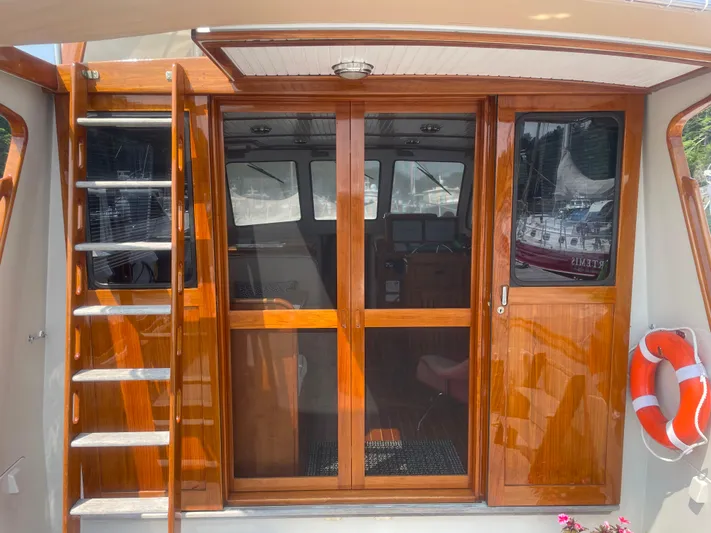 Minkie B Yacht Photos Pics 1997 Lyman-Morse Custom Flybridge yacht with wooden sliding doors and ladder.