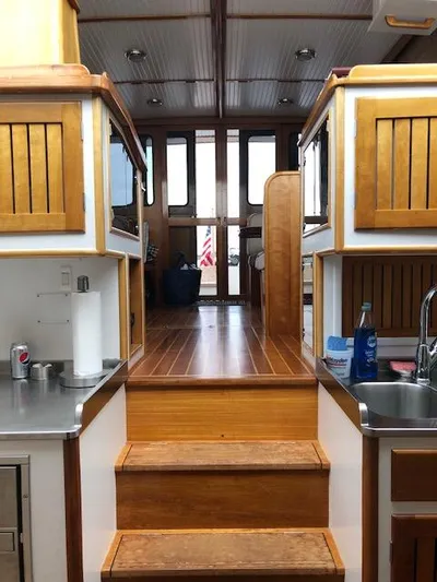 Minkie B Yacht Photos Pics Interior of 1997 Lyman-Morse Custom Flybridge with wooden cabinetry and stainless steel sink.