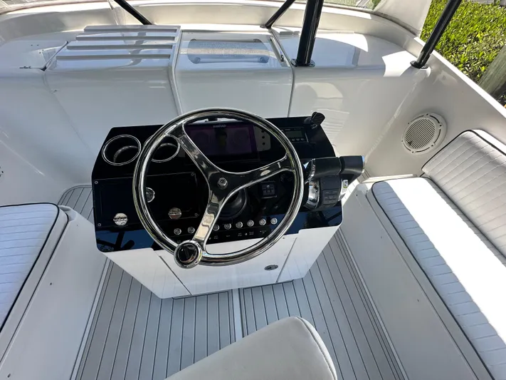  Yacht Photos Pics 2000 Luhrs Tournament 320 Open boat helm with steering wheel and seating.