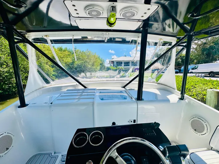  Yacht Photos Pics 2000 Luhrs Tournament 320 Open boat helm with clear canopy and scenic view.