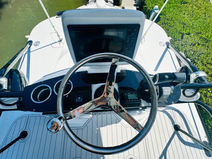  Yacht Photos Pics 2000 Luhrs Tournament 320 Open boat helm with steering wheel and navigation equipment.