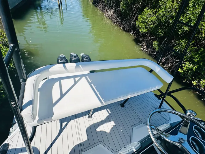  Yacht Photos Pics 2000 Luhrs Tournament 320 Open boat, rear deck view with white seating and water backdrop.