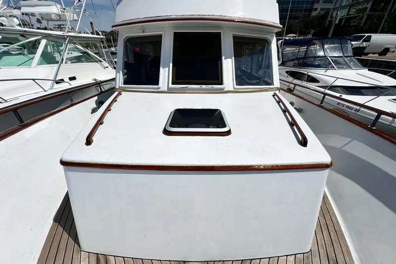 Maren Yacht Photos Pics 1980 Island Gypsy Flush Aft Deck Trawler-Motor Yacht, docked with visible deck and windows.