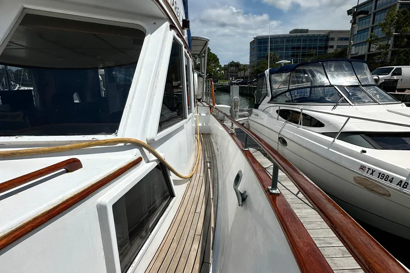 Maren Yacht Photos Pics 1980 Island Gypsy Flush Aft Deck Trawler-Motor Yacht docked beside another boat.