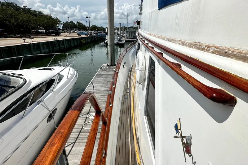 Maren Yacht Photos Pics 1980 Island Gypsy Flush Aft Deck Trawler-Motor Yacht docked beside another boat.