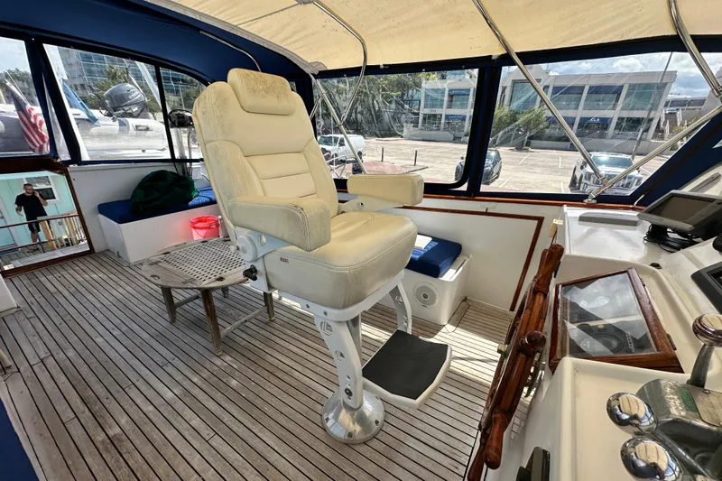 Maren Yacht Photos Pics 1980 Island Gypsy Flush Aft Deck Trawler-Motor Yacht helm with captain's chair and controls.