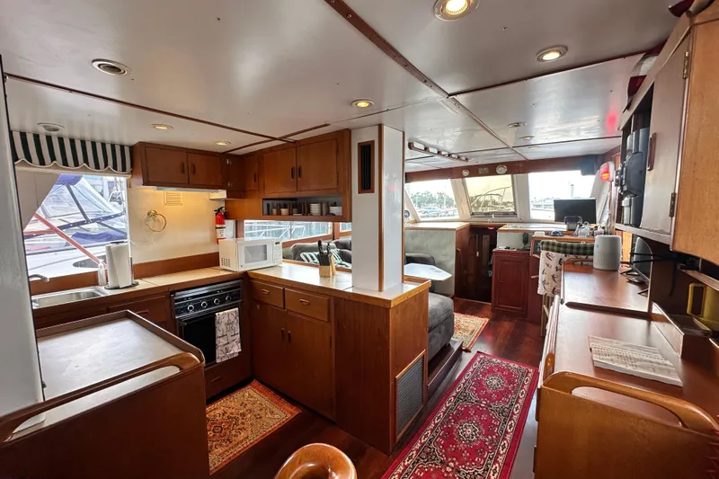 Maren Yacht Photos Pics Interior of 1980 Island Gypsy Flush Aft Deck Trawler-Motor Yacht, featuring cozy kitchen and seating area.