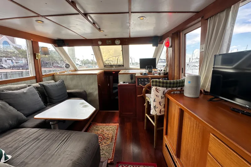 Maren Yacht Photos Pics Interior of 1980 Island Gypsy Flush Aft Deck Trawler-Motor Yacht with cozy seating and navigation area.