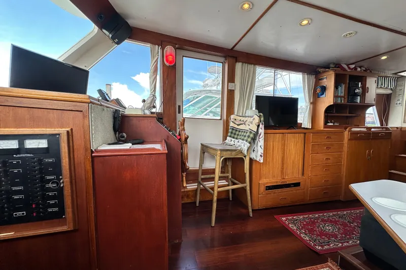Maren Yacht Photos Pics Interior of 1980 Island Gypsy Flush Aft Deck Trawler-Motor Yacht with wooden cabinetry and seating.