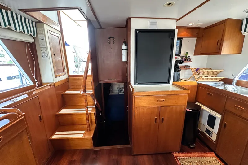 Maren Yacht Photos Pics Interior of 1980 Island Gypsy Flush Aft Deck Trawler-Motor Yacht with wooden cabinetry and stairs.