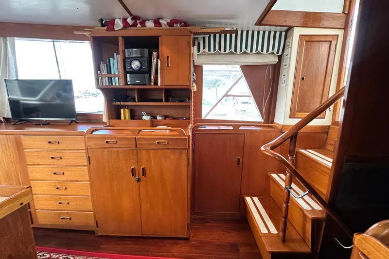 Maren Yacht Photos Pics Interior of 1980 Island Gypsy Flush Aft Deck Trawler-Motor Yacht with wooden cabinetry and stairs.