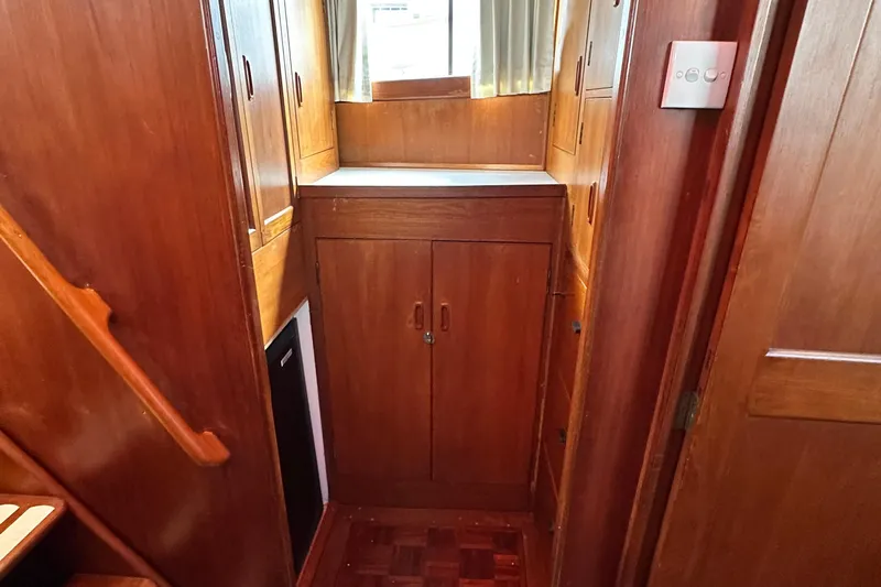 Maren Yacht Photos Pics 1980 Island Gypsy Flush Aft Deck Trawler-Motor Yacht interior with wooden cabinetry and stairs.