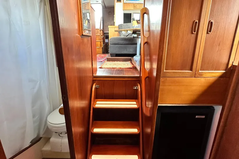 Maren Yacht Photos Pics Interior of 1980 Island Gypsy Flush Aft Deck Trawler-Motor Yacht with wooden stairs and cabinetry.