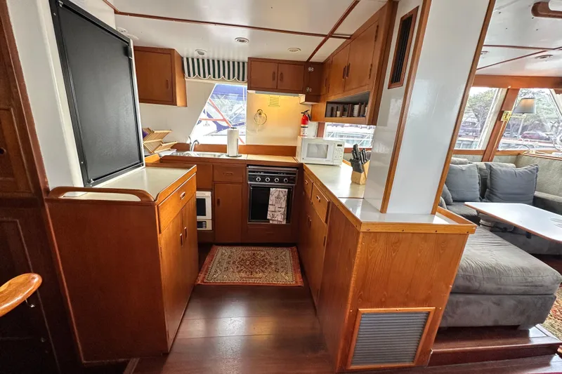 Maren Yacht Photos Pics Interior of 1980 Island Gypsy Flush Aft Deck Trawler-Motor Yacht with cozy kitchen and seating area.