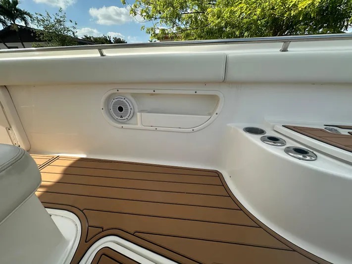  Yacht Photos Pics 2013 Boston Whaler 320 Outrage interior with teak flooring and speaker detail.