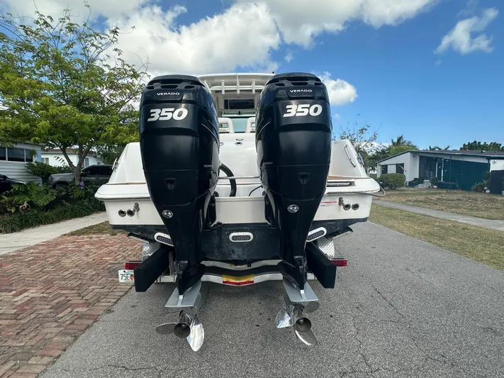  Yacht Photos Pics 2013 Boston Whaler 320 Outrage with twin 350 Verado engines, parked on a street.