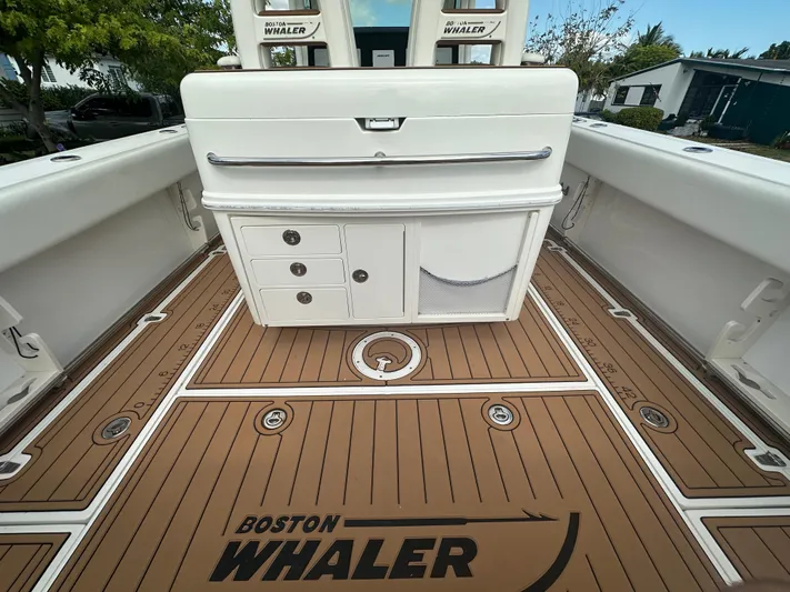  Yacht Photos Pics 2013 Boston Whaler 320 Outrage boat interior with storage compartments and teak-style flooring.