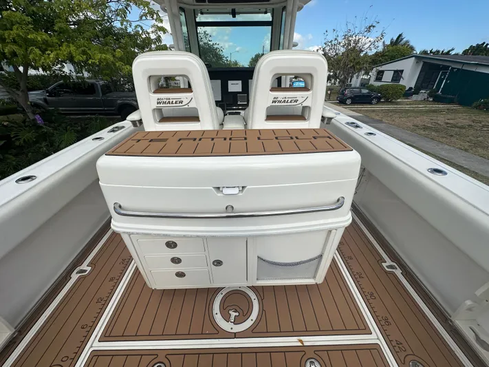 Yacht Photos Pics 2013 Boston Whaler 320 Outrage boat interior with seating and storage compartments.