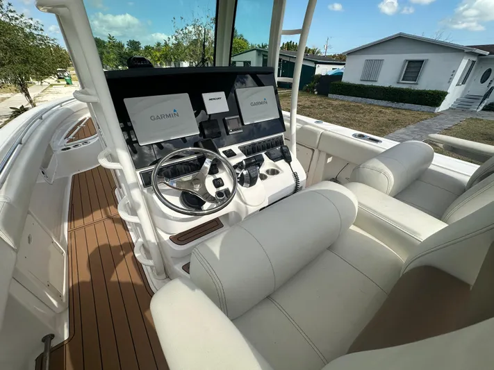  Yacht Photos Pics 2013 Boston Whaler 320 Outrage helm with Garmin displays and luxurious seating.