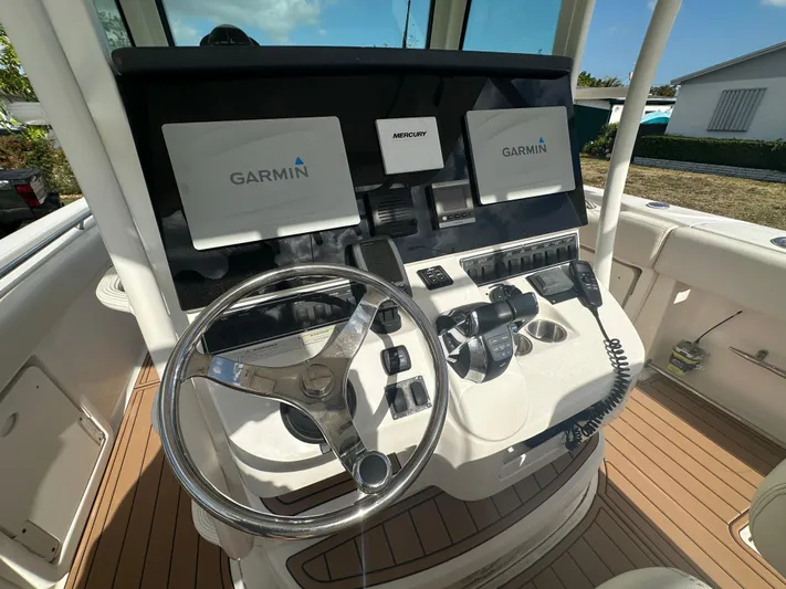  Yacht Photos Pics 2013 Boston Whaler 320 Outrage helm with Garmin displays and Mercury controls.