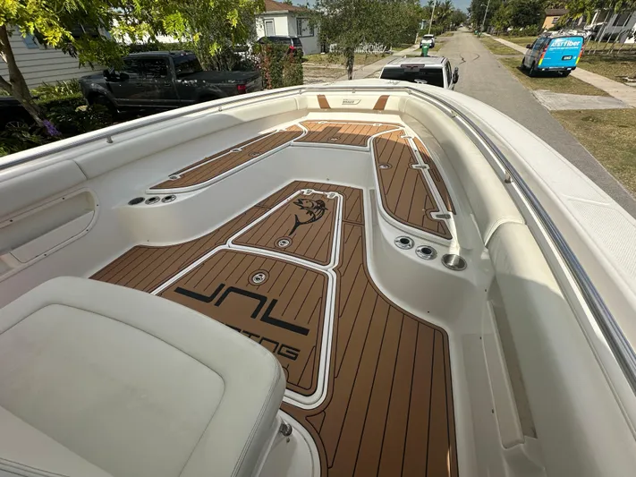  Yacht Photos Pics 2013 Boston Whaler 320 Outrage boat with custom deck flooring, parked on a residential street.