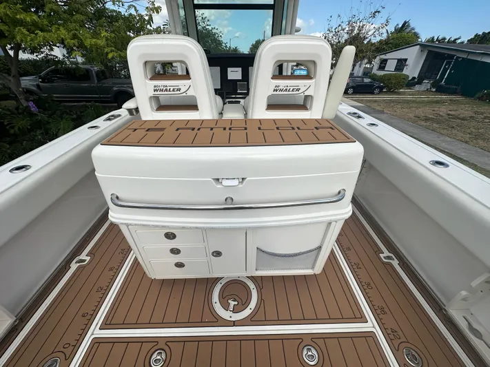  Yacht Photos Pics 2013 Boston Whaler 320 Outrage boat interior with seating and storage compartments.