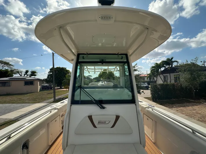  Yacht Photos Pics 2013 Boston Whaler 320 Outrage boat interior with clear sky background.