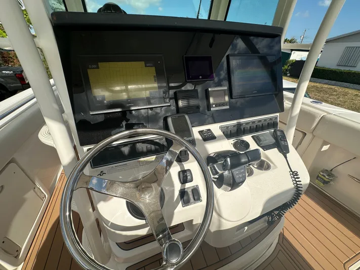 Yacht Photos Pics 2013 Boston Whaler 320 Outrage helm with navigation screens and controls.