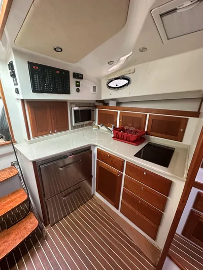 Waters Edge Yacht Photos Pics 2018 Back Cove Downeast 37 yacht kitchen with modern appliances and wood cabinetry.