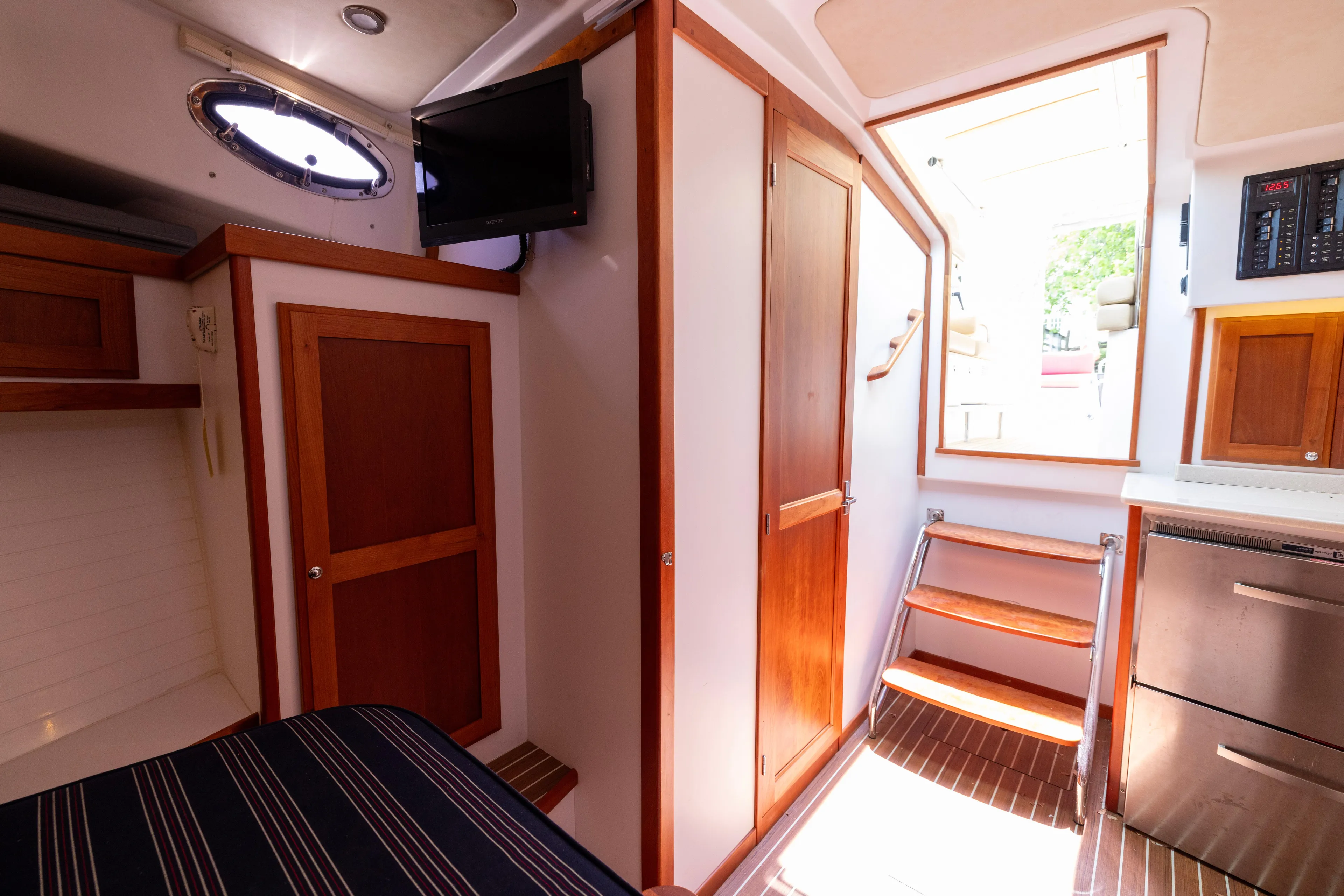 Waters Edge Yacht Photos Pics 2018 Back Cove Downeast 37 interior with wooden cabinetry, stairs, and modern amenities.