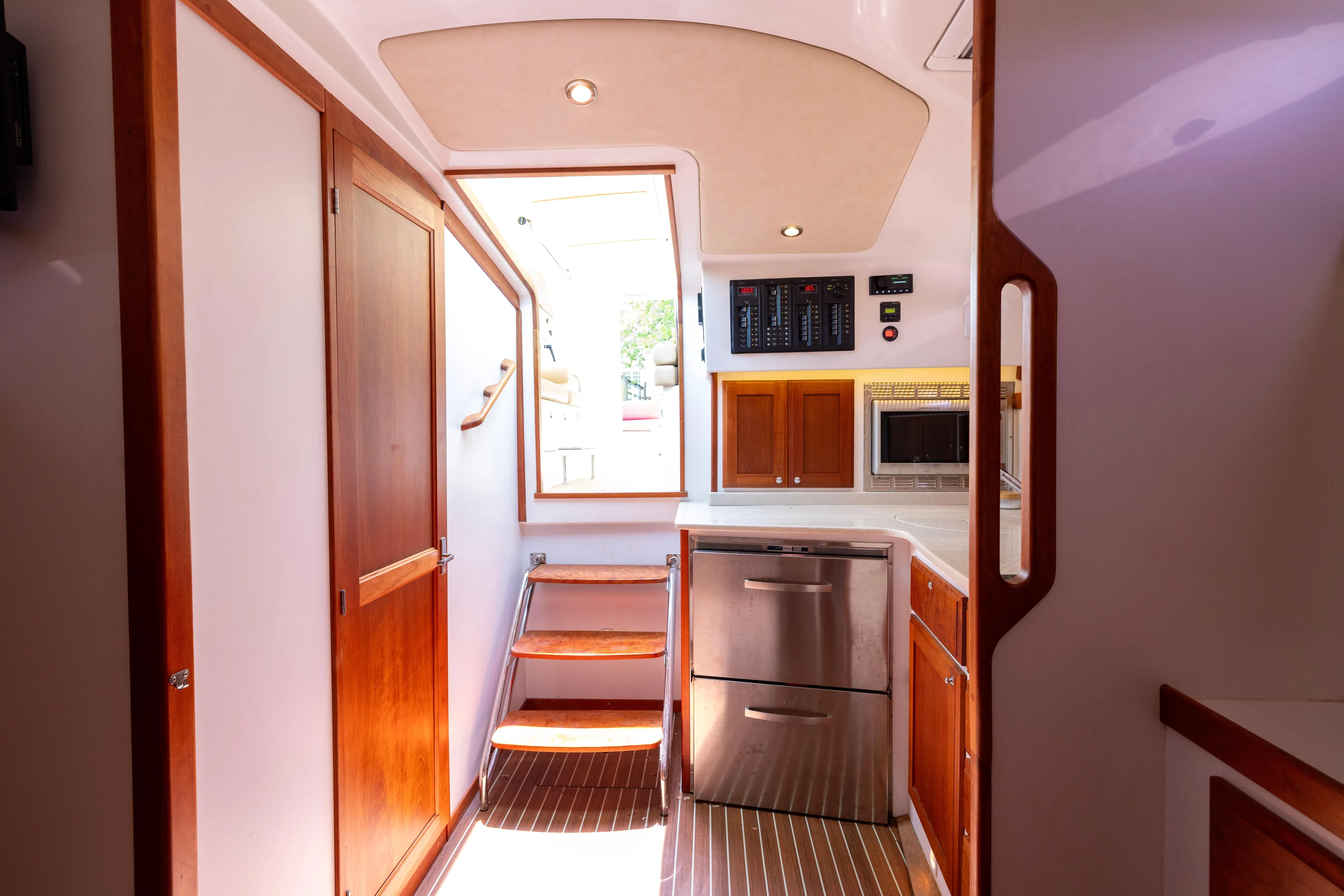 Waters Edge Yacht Photos Pics Interior of 2018 Back Cove Downeast 37 yacht, featuring wooden cabinetry and modern appliances.