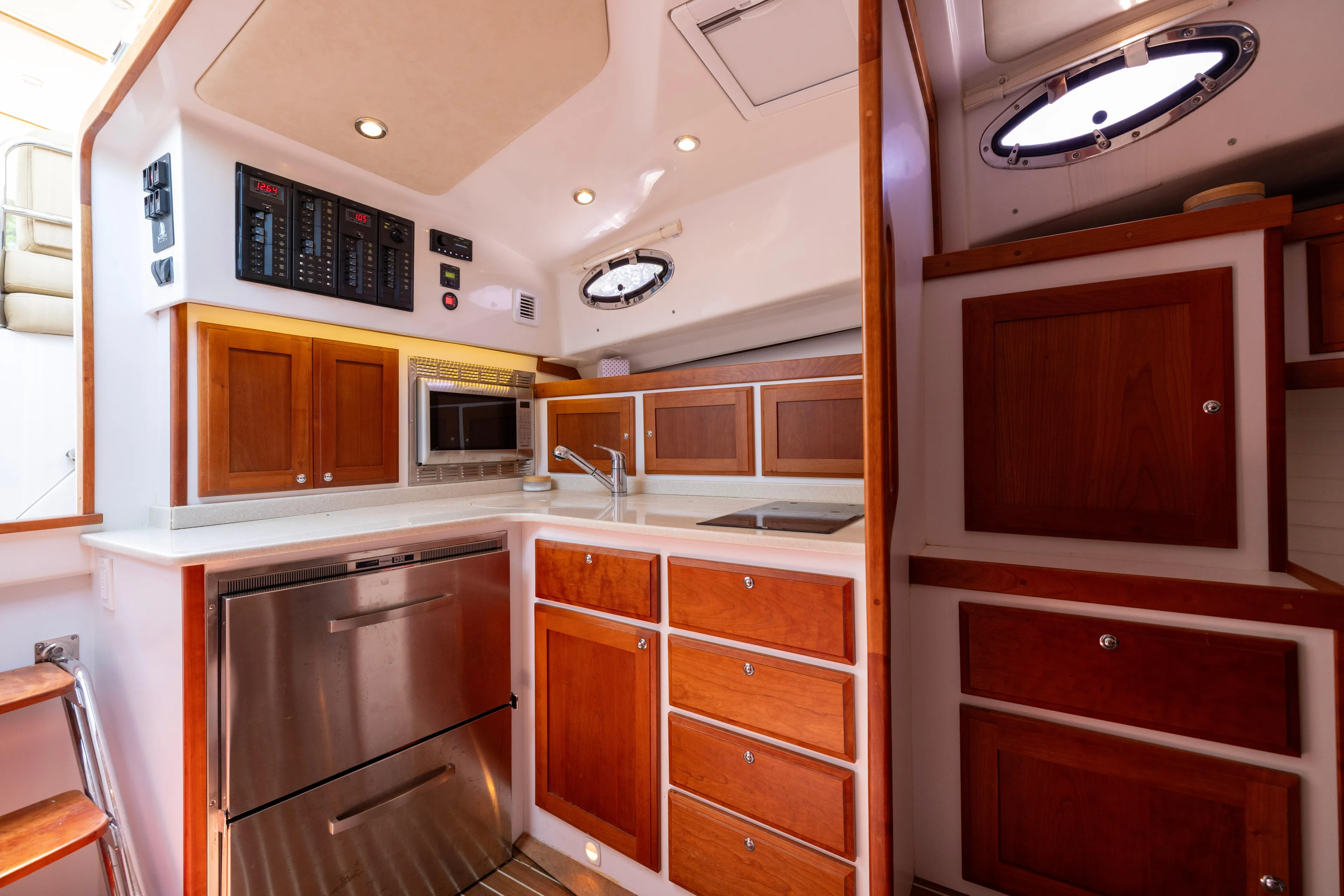Waters Edge Yacht Photos Pics 2018 Back Cove Downeast 37 yacht kitchen with wood cabinets and modern appliances.