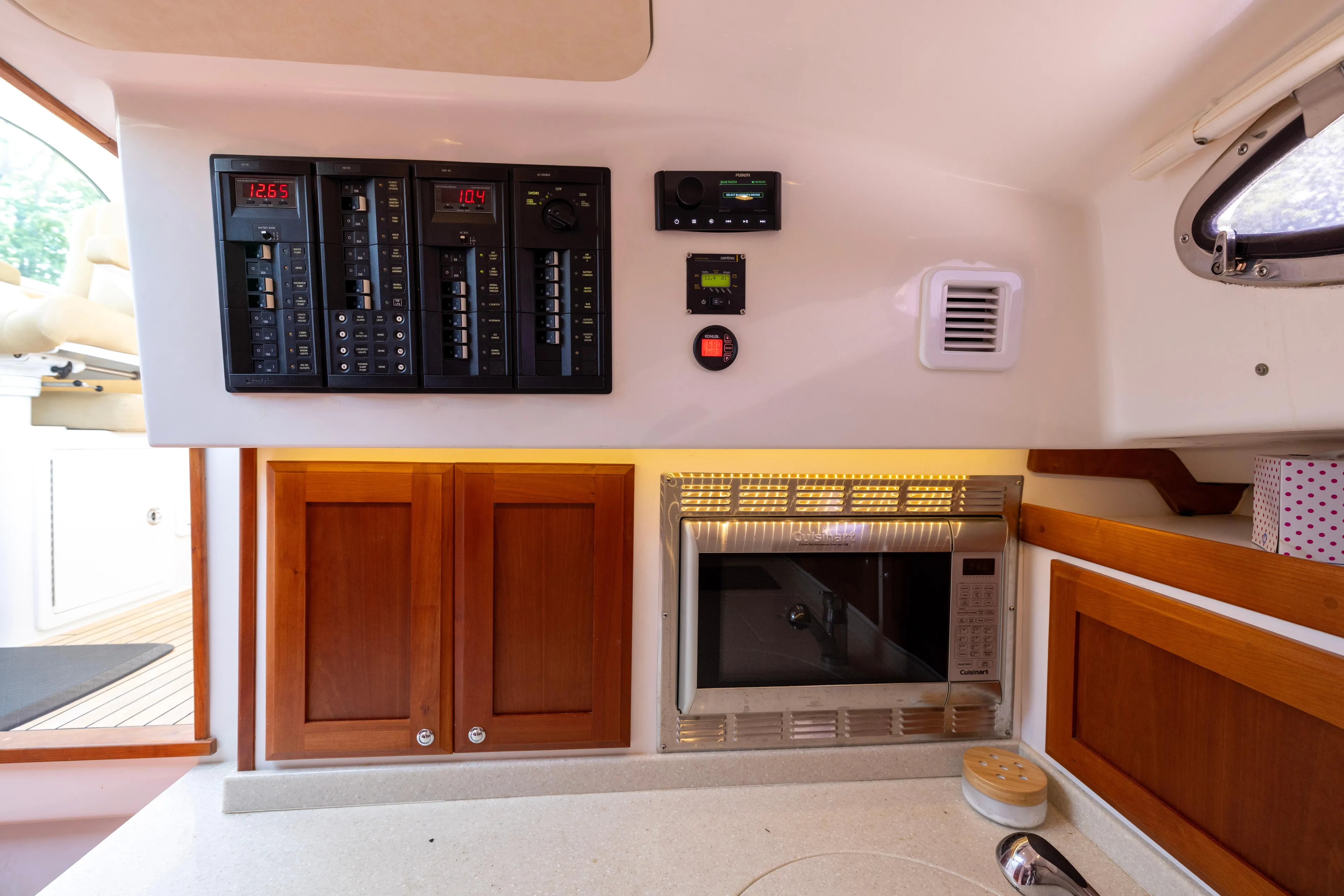 Waters Edge Yacht Photos Pics Control panel and kitchen area inside a 2018 Back Cove Downeast 37 boat.