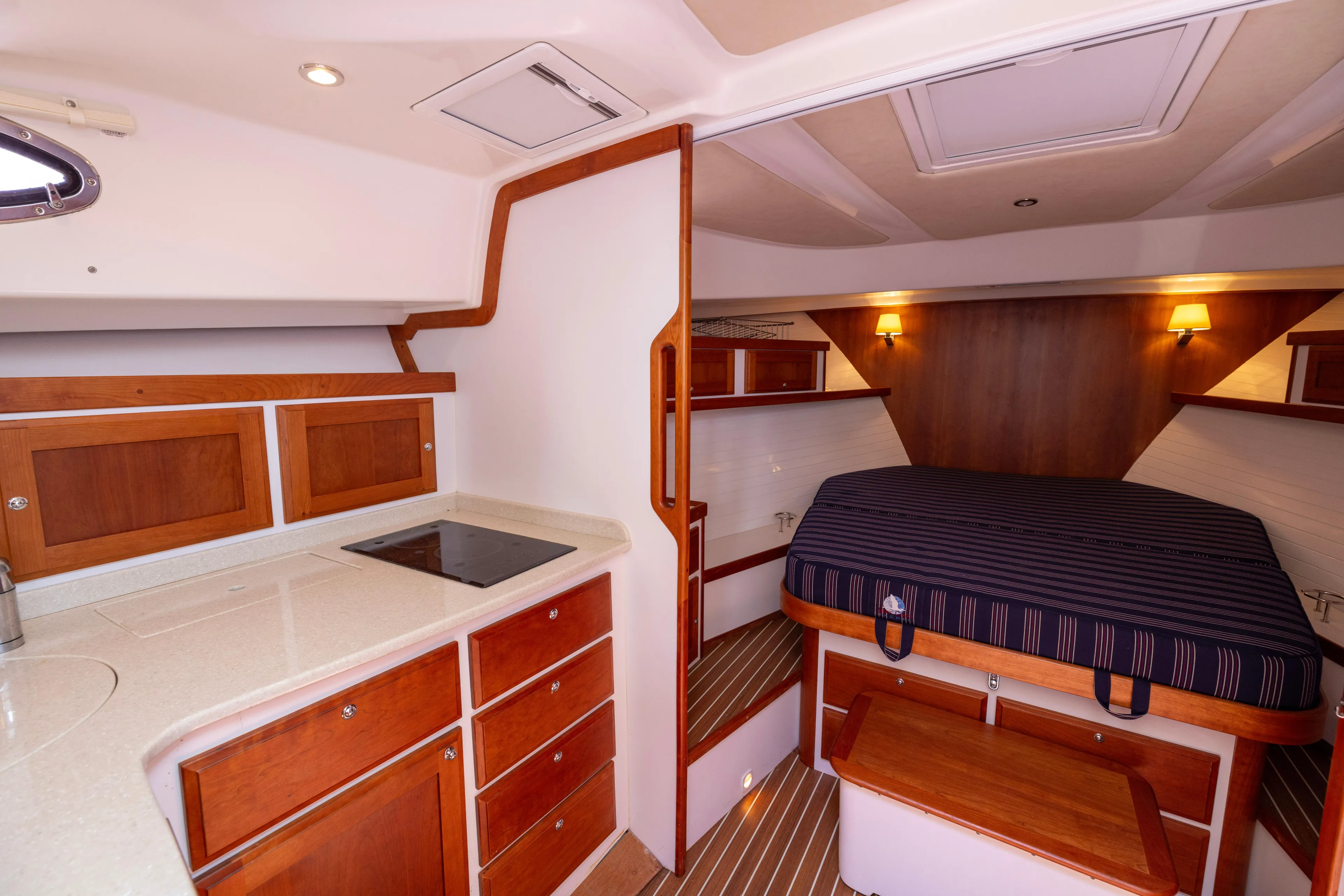 Waters Edge Yacht Photos Pics 2018 Back Cove Downeast 37 interior with kitchenette and cozy sleeping area.