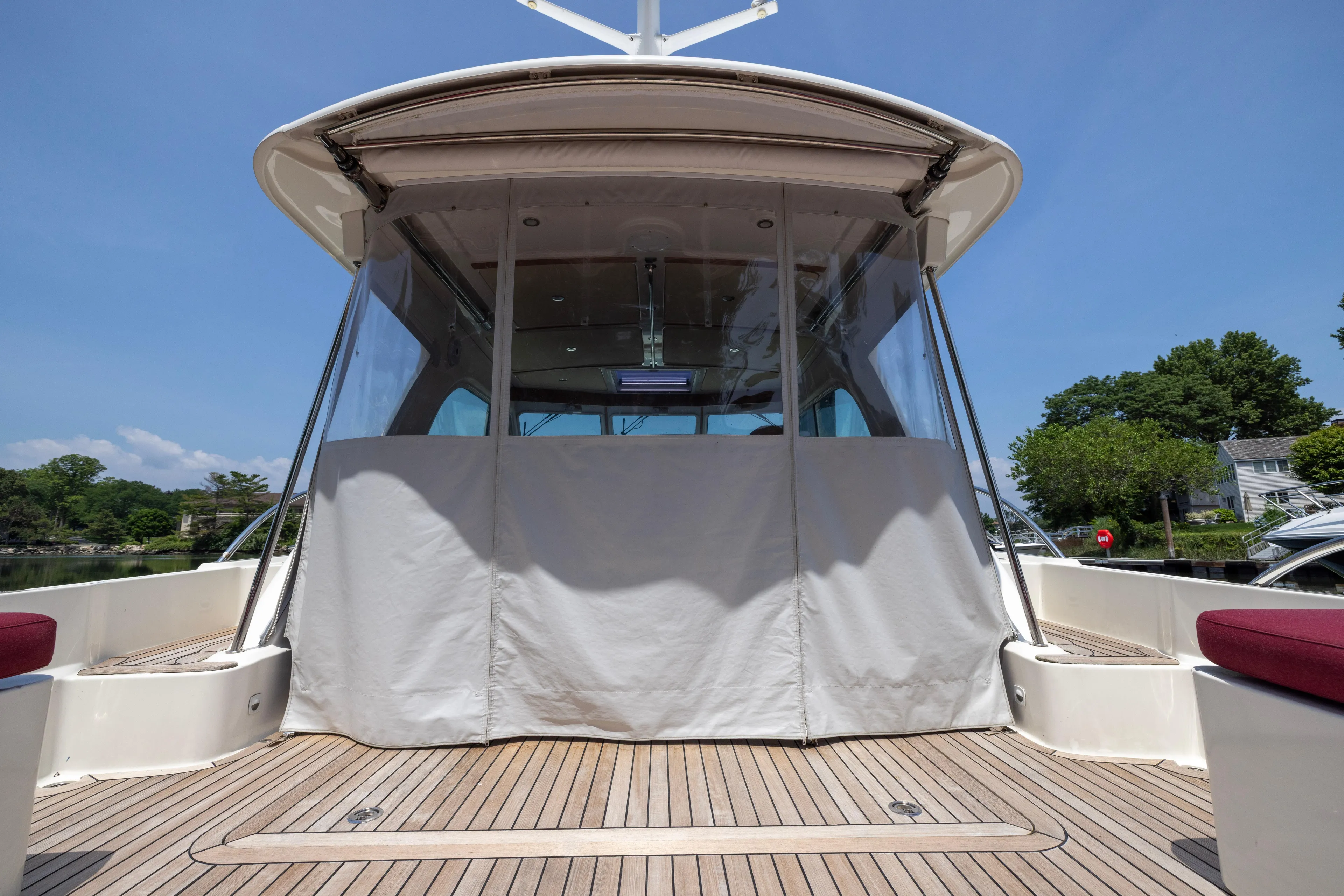 Waters Edge Yacht Photos Pics 2018 Back Cove Downeast 37 yacht with covered deck, wooden flooring, and clear skies.