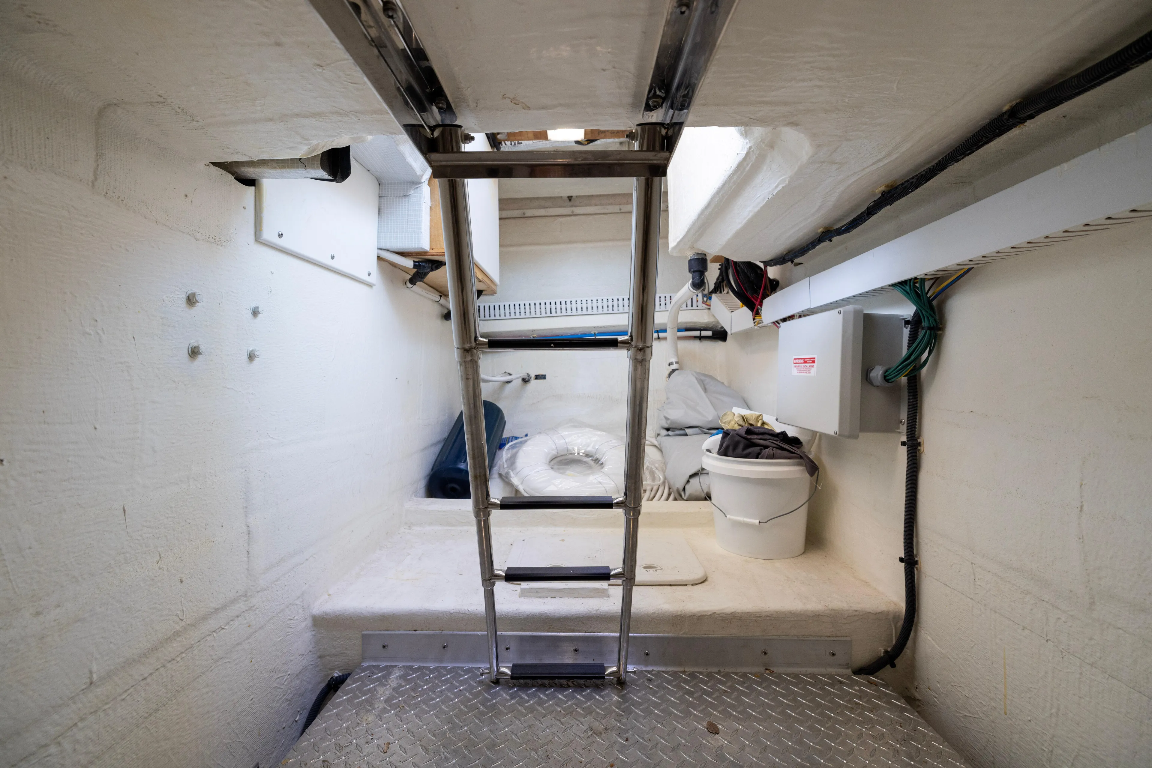 Waters Edge Yacht Photos Pics 2018 Back Cove Downeast 37 engine room with ladder and storage space.