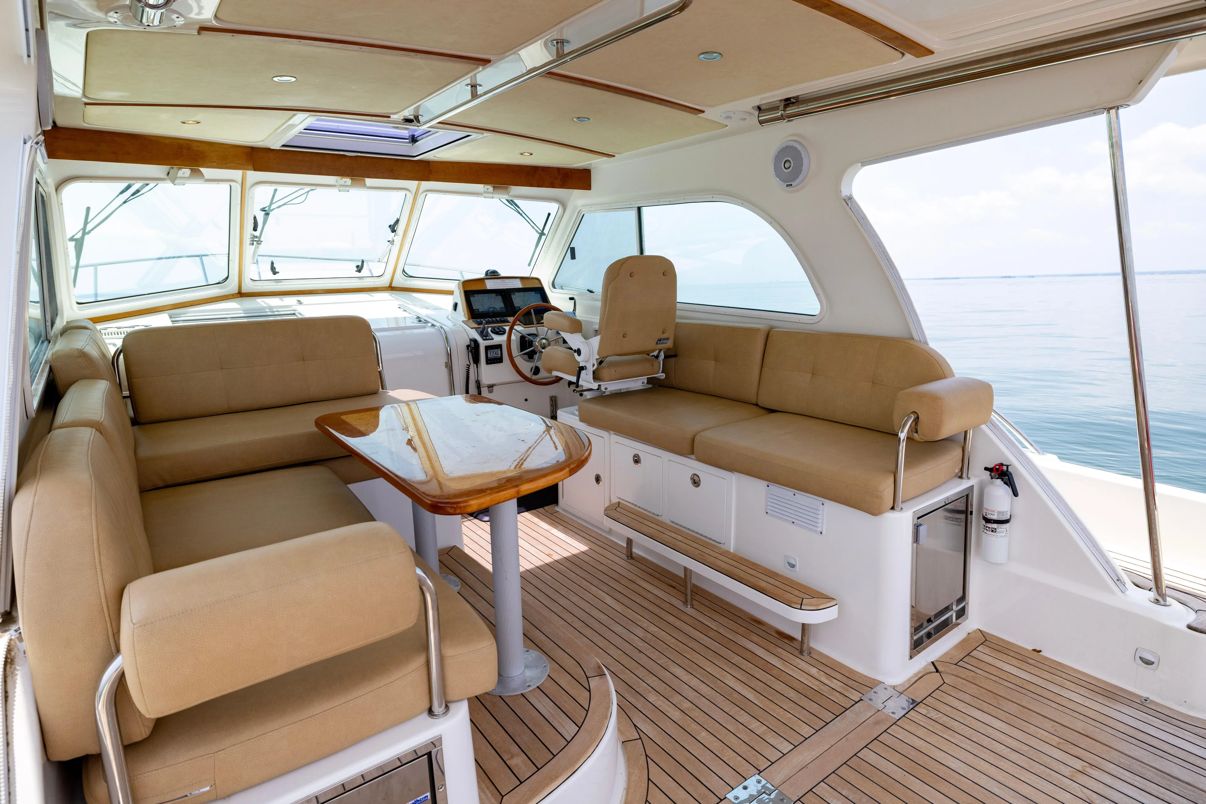 Waters Edge Yacht Photos Pics Interior of 2018 Back Cove Downeast 37 yacht with beige seating and wooden accents.