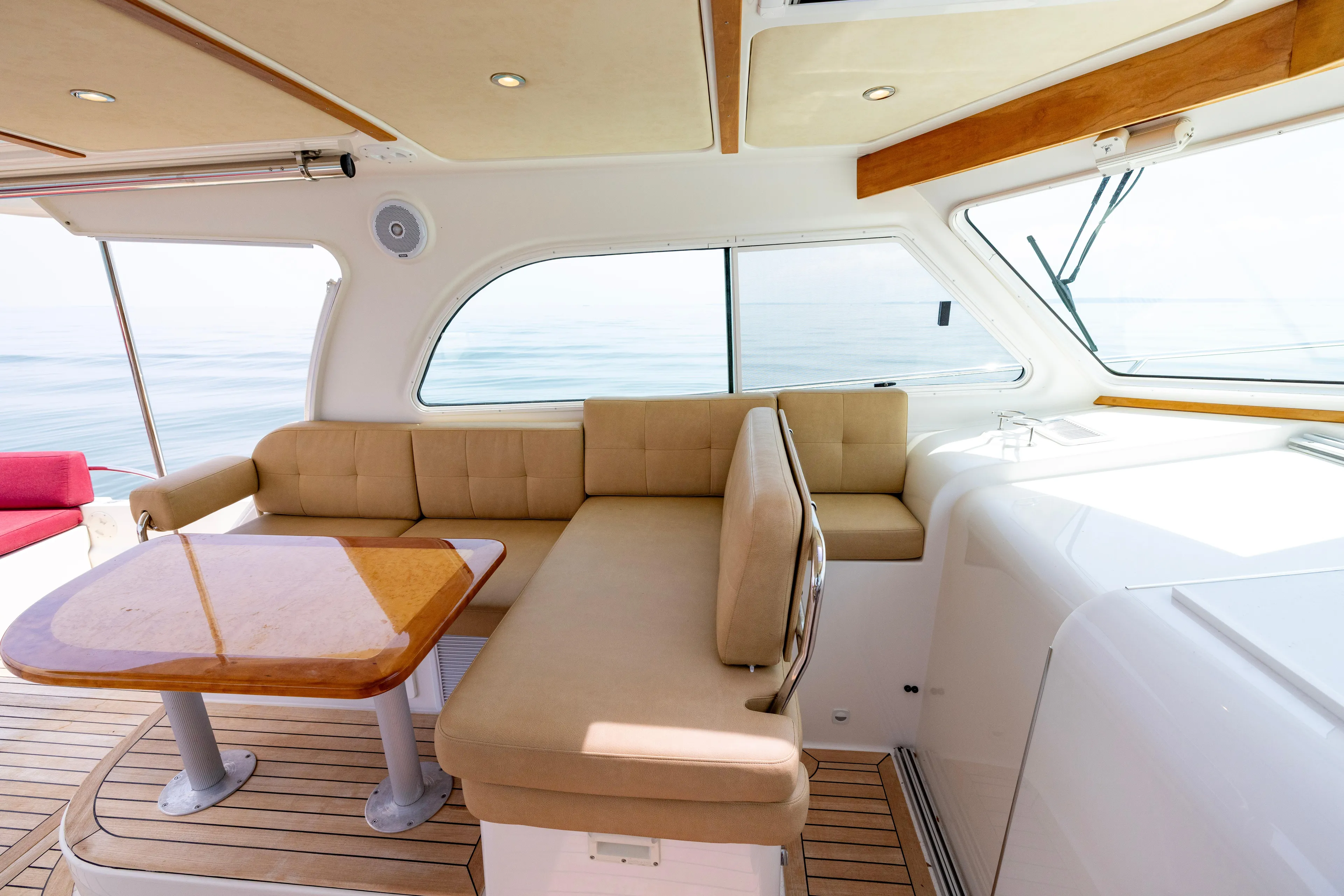 Waters Edge Yacht Photos Pics Luxurious interior of 2018 Back Cove Downeast 37 yacht with beige seating and wooden table.