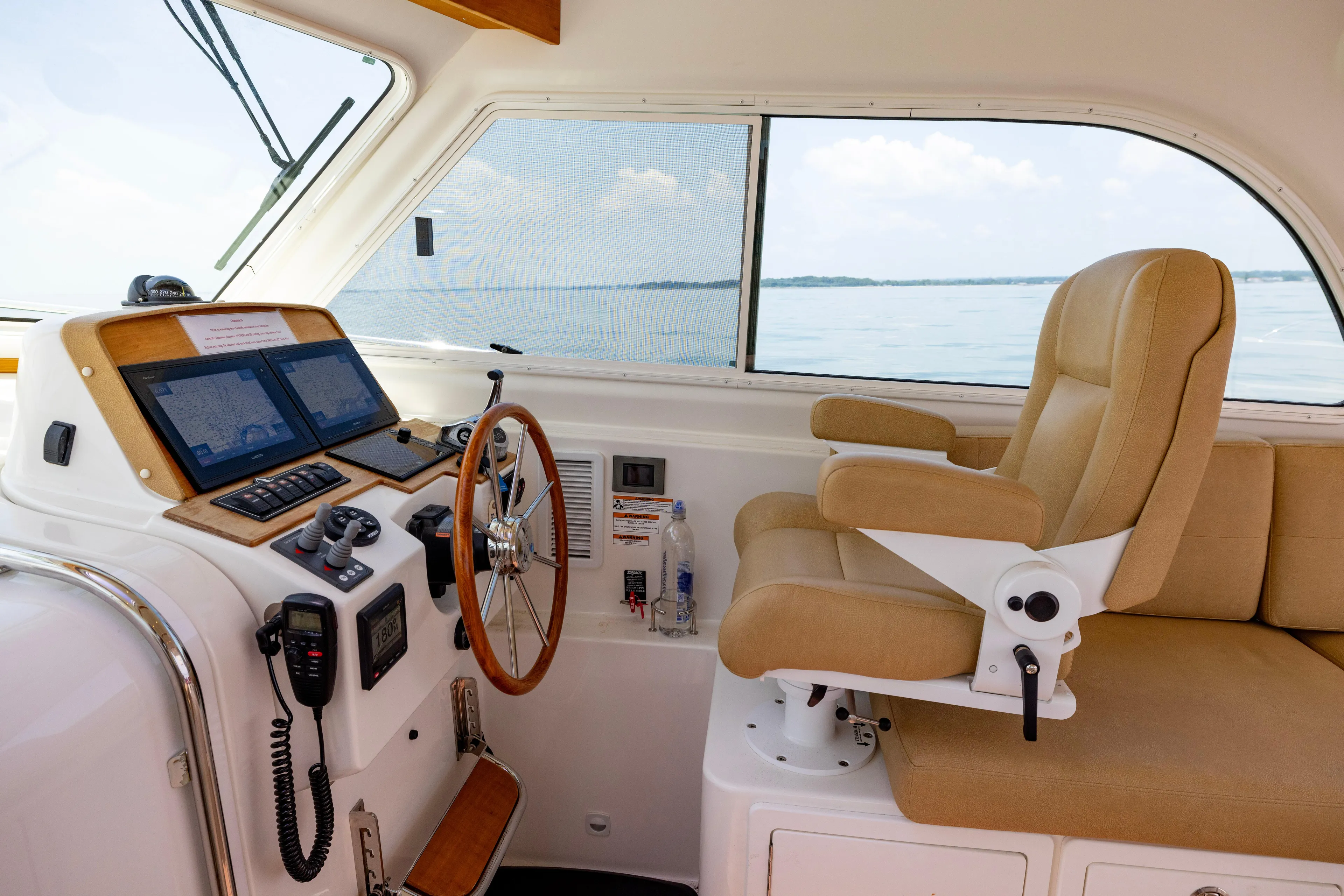 Waters Edge Yacht Photos Pics Helm of 2018 Back Cove Downeast 37 with navigation equipment and captain's chair.