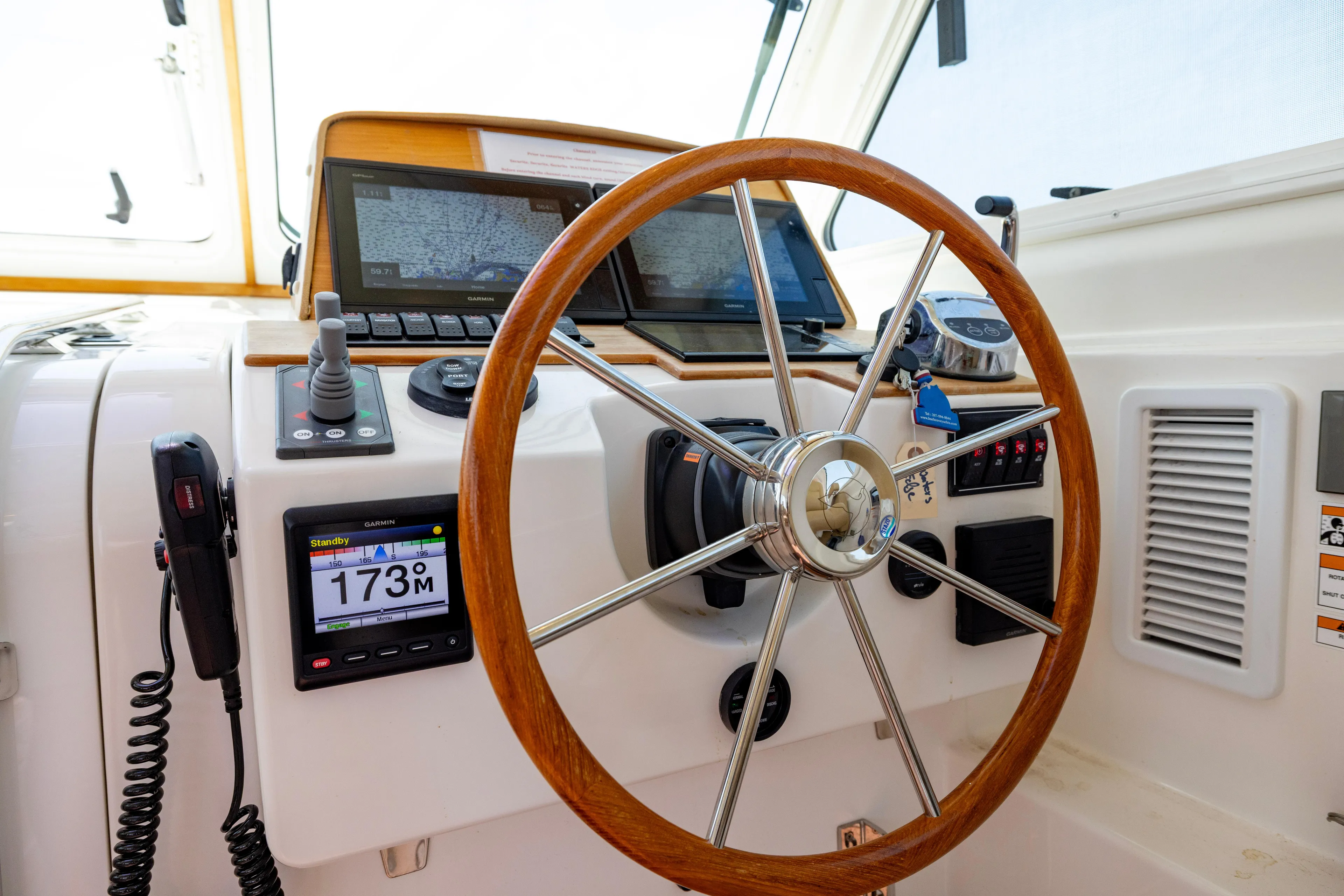 Waters Edge Yacht Photos Pics Helm of 2018 Back Cove Downeast 37 with navigation equipment and wooden steering wheel.