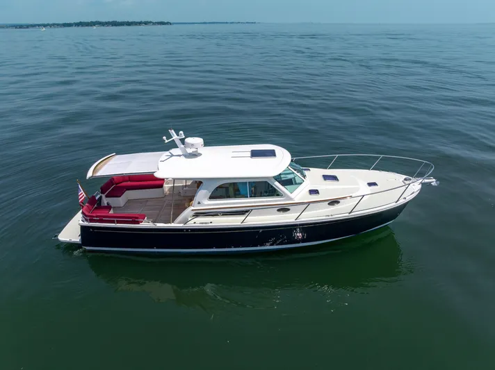 Waters Edge Yacht Photos Pics 2018 Back Cove Downeast 37 yacht on calm water, featuring sleek design and spacious deck.