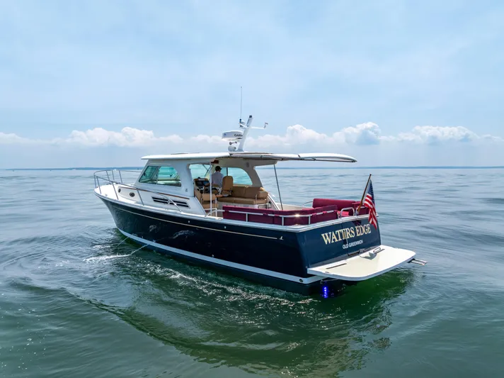 Waters Edge Yacht Photos Pics 2018 Back Cove Downeast 37 yacht cruising on calm waters under a clear sky.