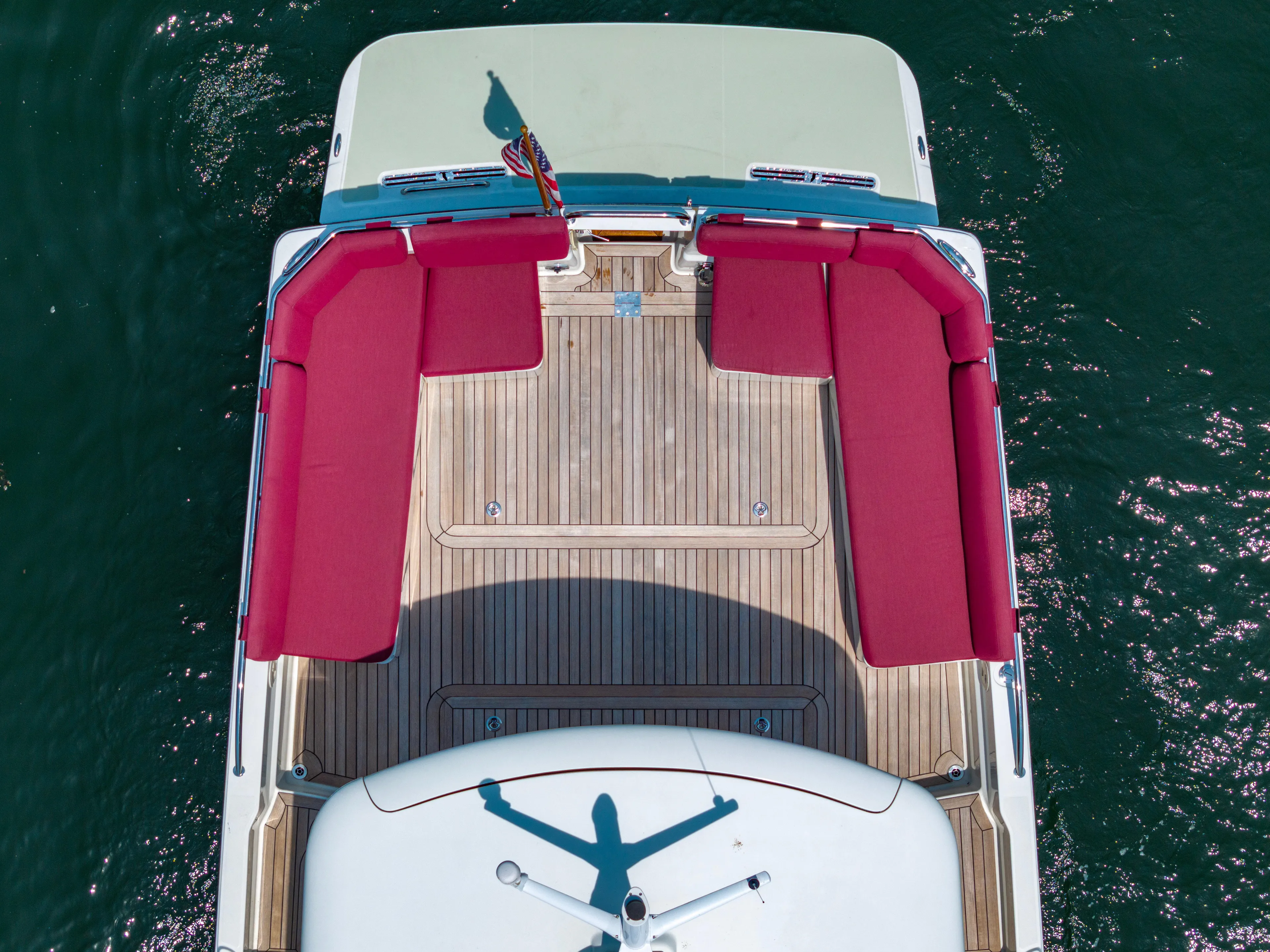 Waters Edge Yacht Photos Pics Aerial view of 2018 Back Cove Downeast 37 boat with red seating and wooden deck.