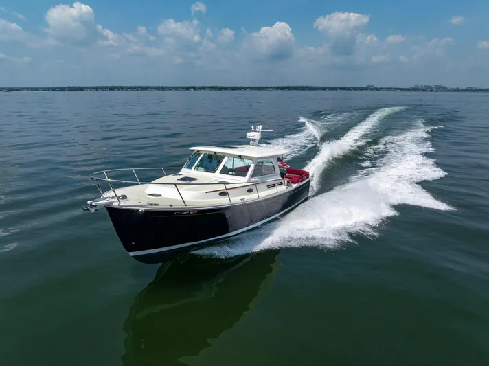 Waters Edge Yacht Photos Pics 2018 Back Cove Downeast 37 cruising on open water under a clear sky.