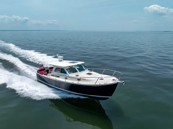 Waters Edge Yacht Photos Pics 2018 Back Cove Downeast 37 cruising on open water under clear skies.