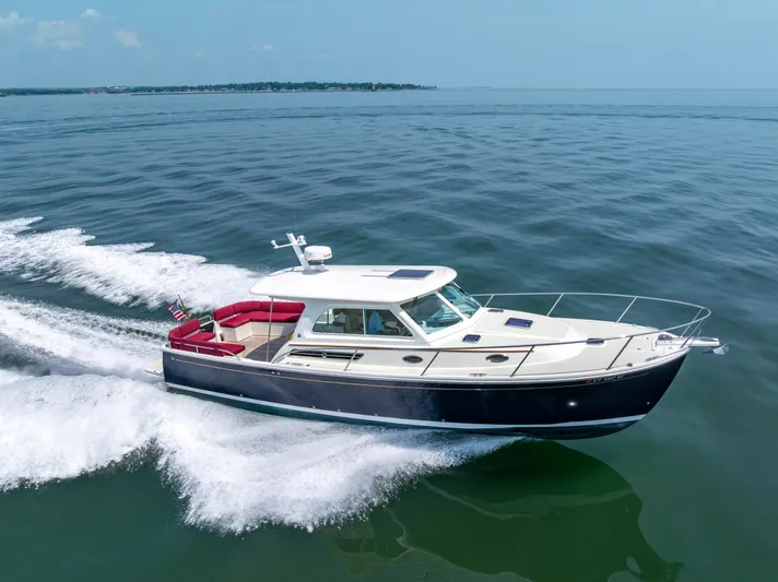 Waters Edge Yacht Photos Pics 2018 Back Cove Downeast 37 cruising on open water, showcasing sleek design and performance.