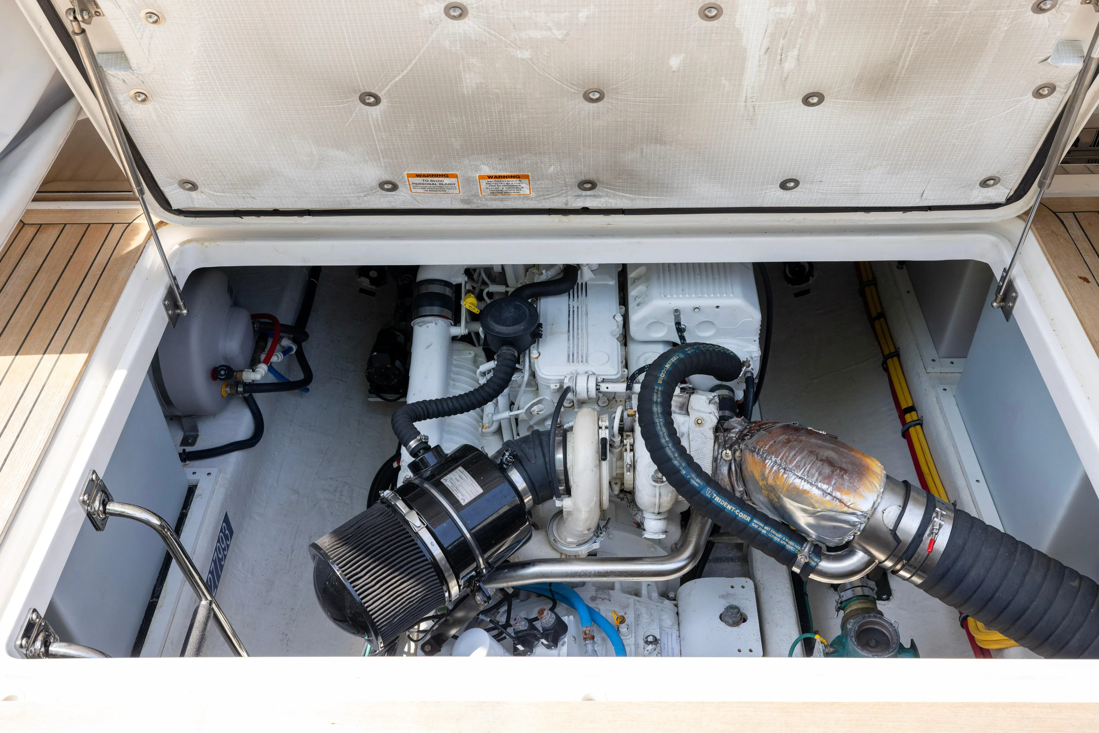 Waters Edge Yacht Photos Pics Engine compartment of a 2018 Back Cove Downeast 37 boat, showcasing mechanical components.