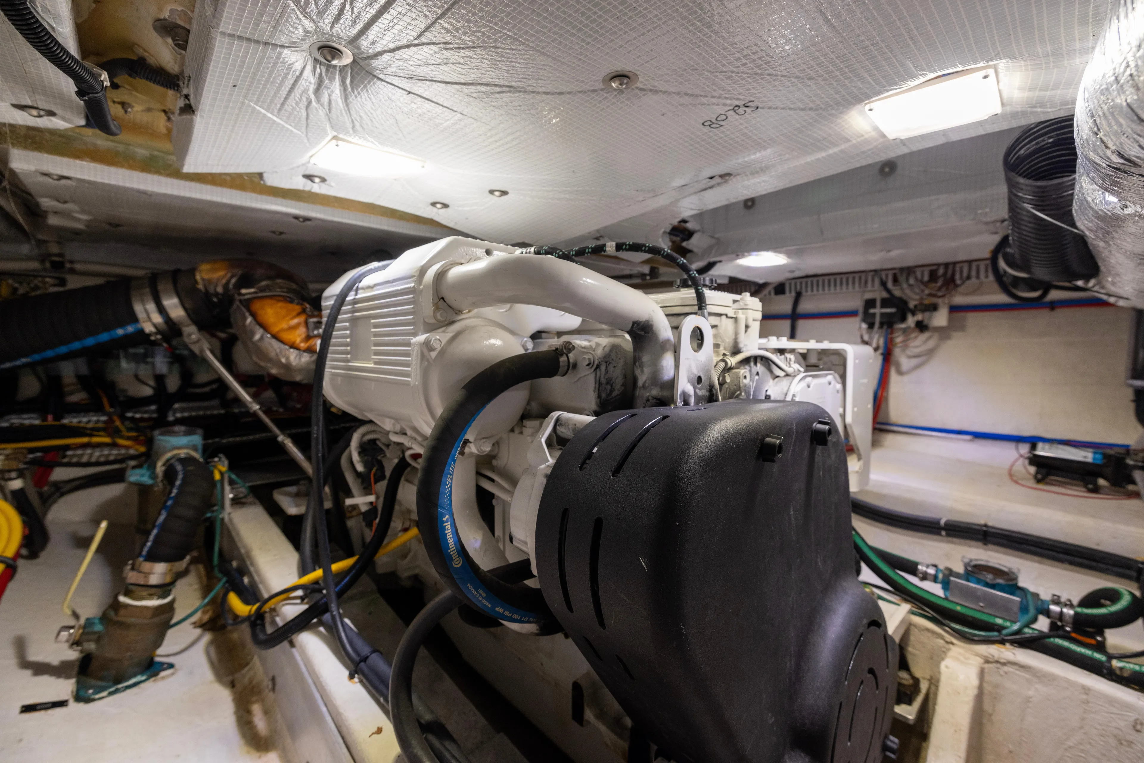 Waters Edge Yacht Photos Pics Engine room of 2018 Back Cove Downeast 37 boat, showcasing mechanical components and wiring.