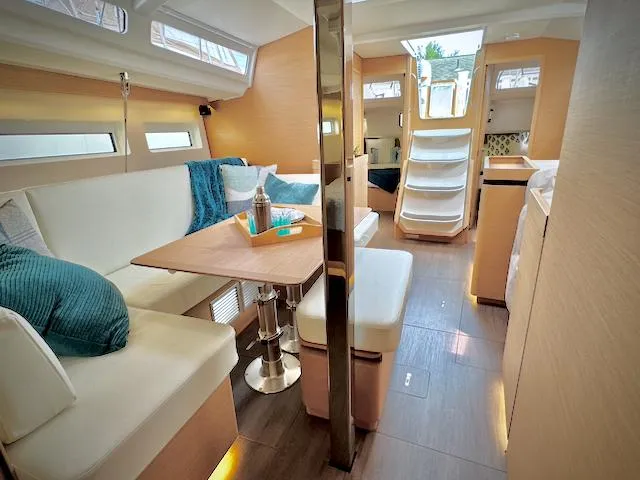 In Stock 440 #442 Yacht Photos Pics 2023 Jeanneau Sun Odyssey 440 interior, modern design with cozy seating and natural light.